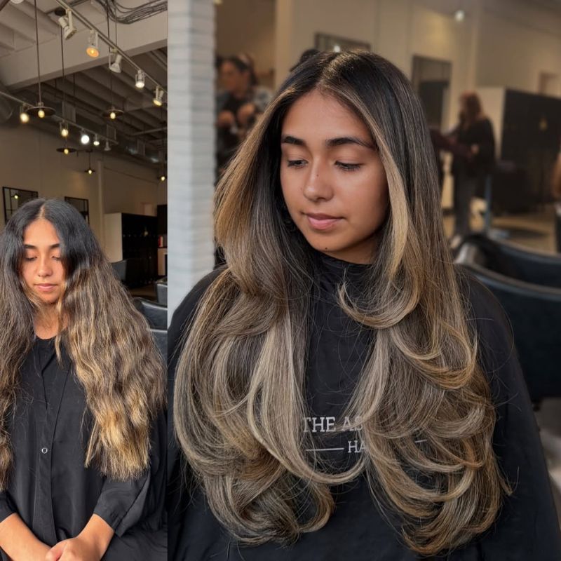 Face-framing blonde highlights adding brightness and contrast to long dark hair.