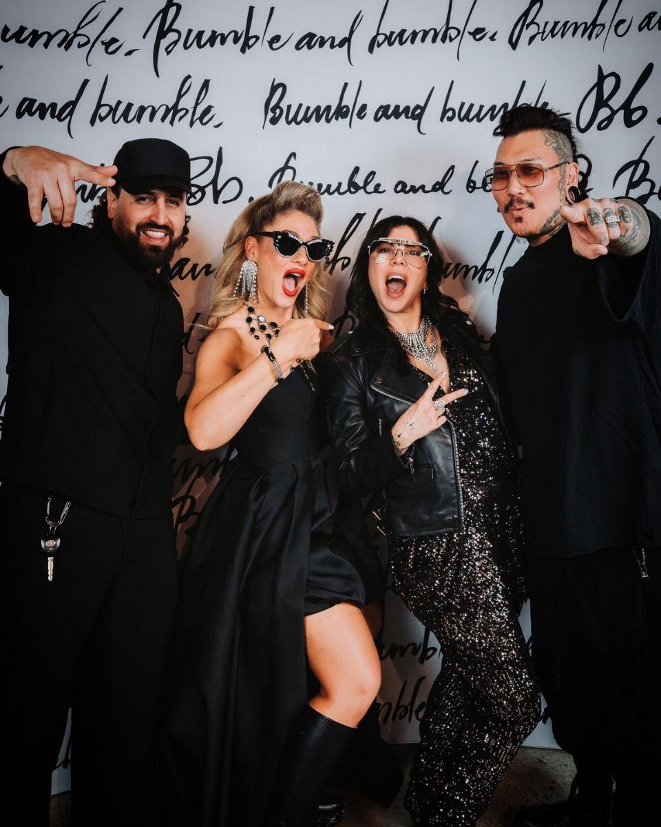 Ashlee Norman poses with three fellow House of Bumble Collective educators in front of a Bumble and bumble backdrop in Las Vegas.