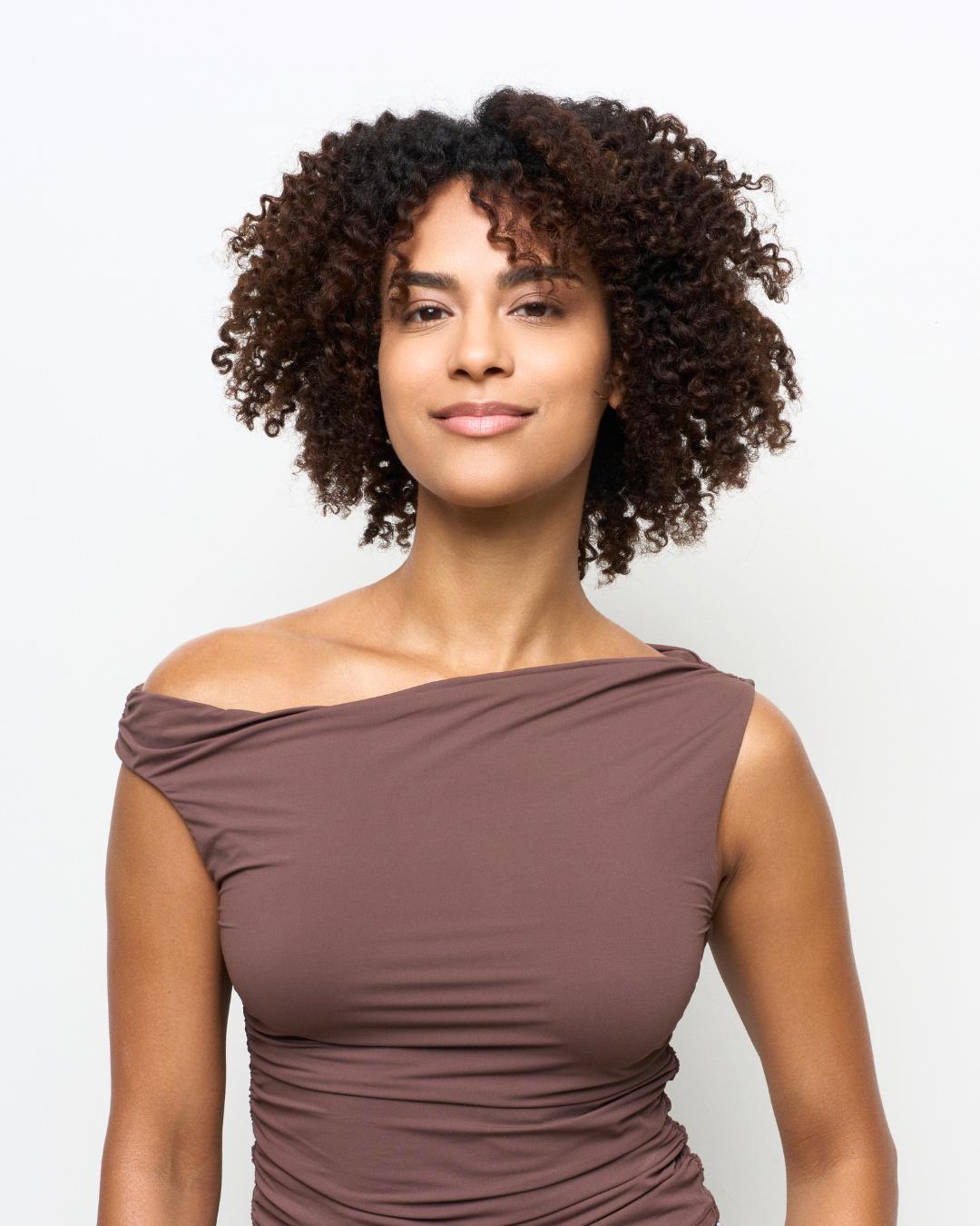 Before image showing natural curly hair with minimal styling