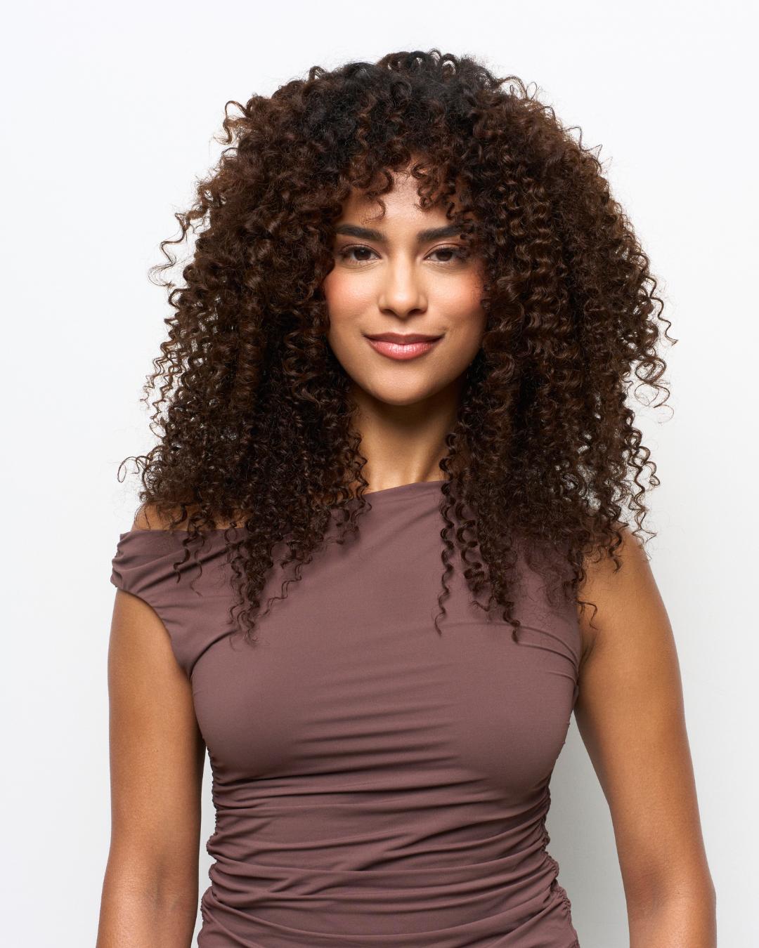 After image featuring Deep Spiral curly extensions with enhanced volume and definition