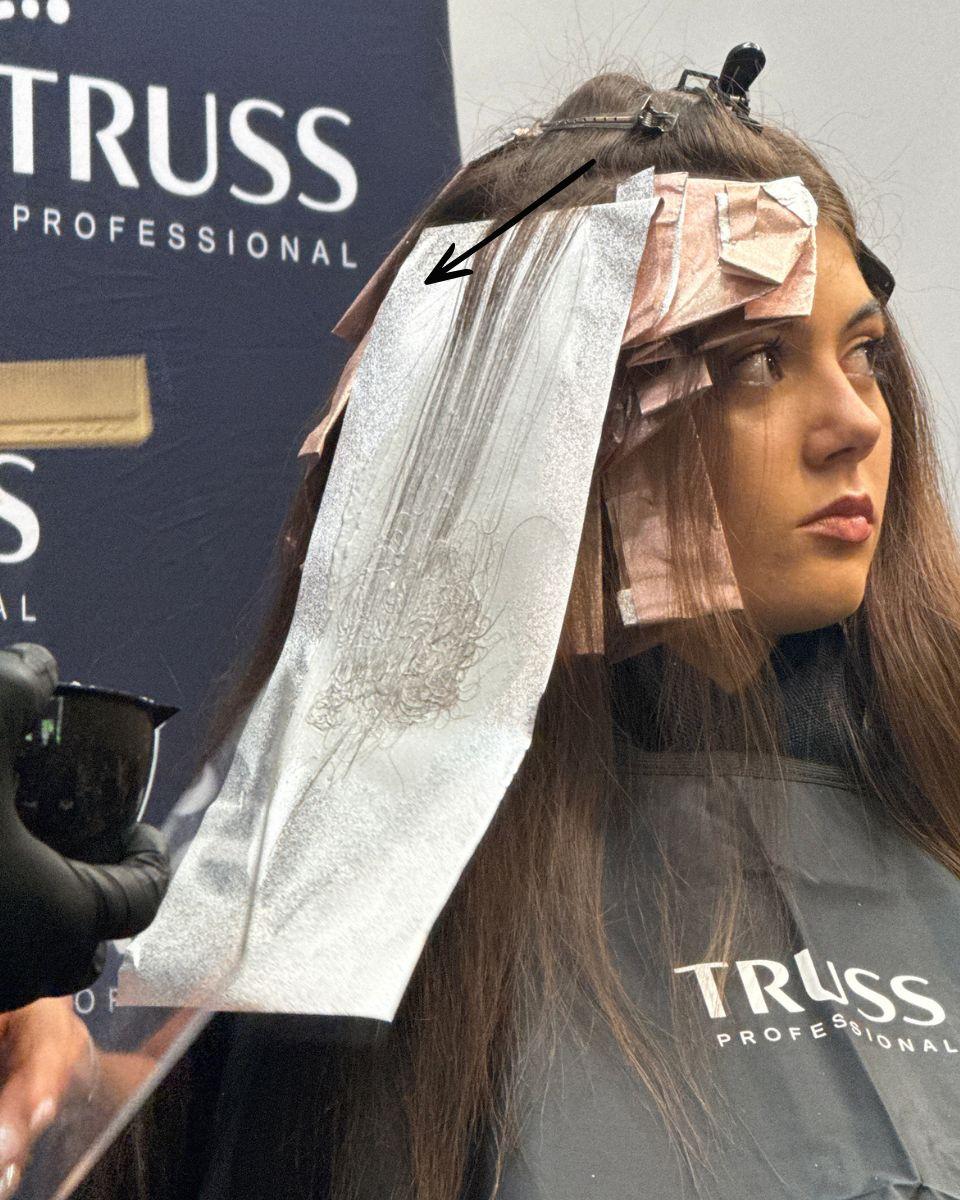 Close-up of a foil application highlighting full saturation through the ends, a key technique for creating a balayage effect with foils.