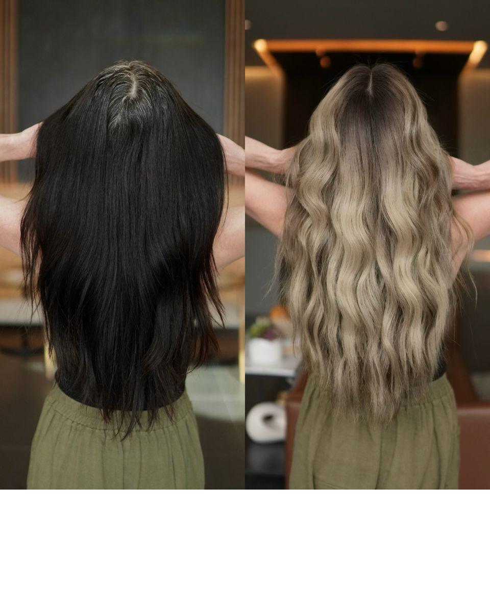 Back-view before-and-after of the client’s long hair transformed from permanent black color to a dimensional beige blonde with a soft root melt and blended waves.