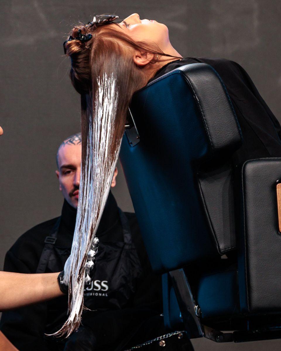 Danilo Herbert demonstrates a blonding technique on a section of long hair during his Free Hands Blond class at TRUSS Connection Global.