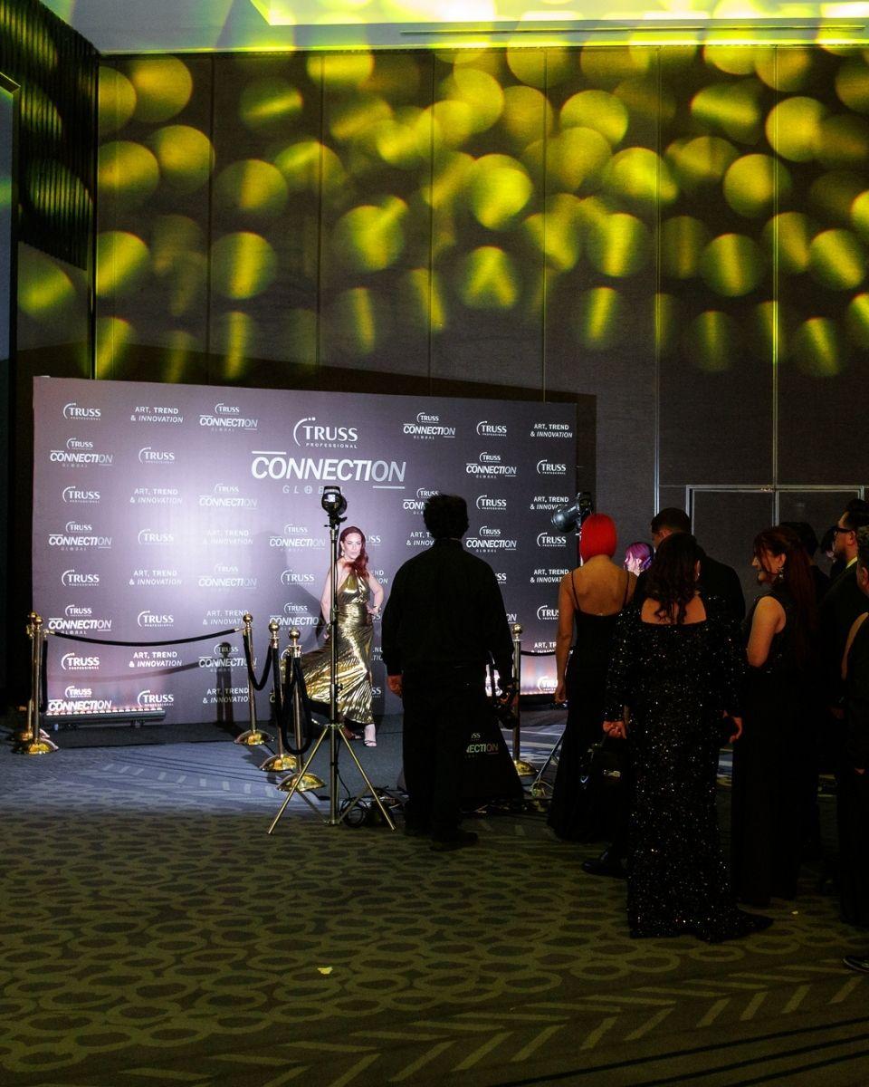 Guests gather at the glam bot video experience during the black-tie gala at TRUSS Connection Global.