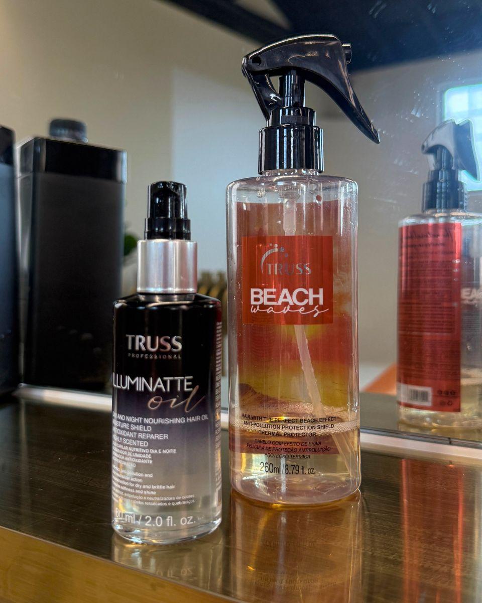 TRUSS Illuminate Oil and Beach Waves spray displayed on a salon station for styling and shine.