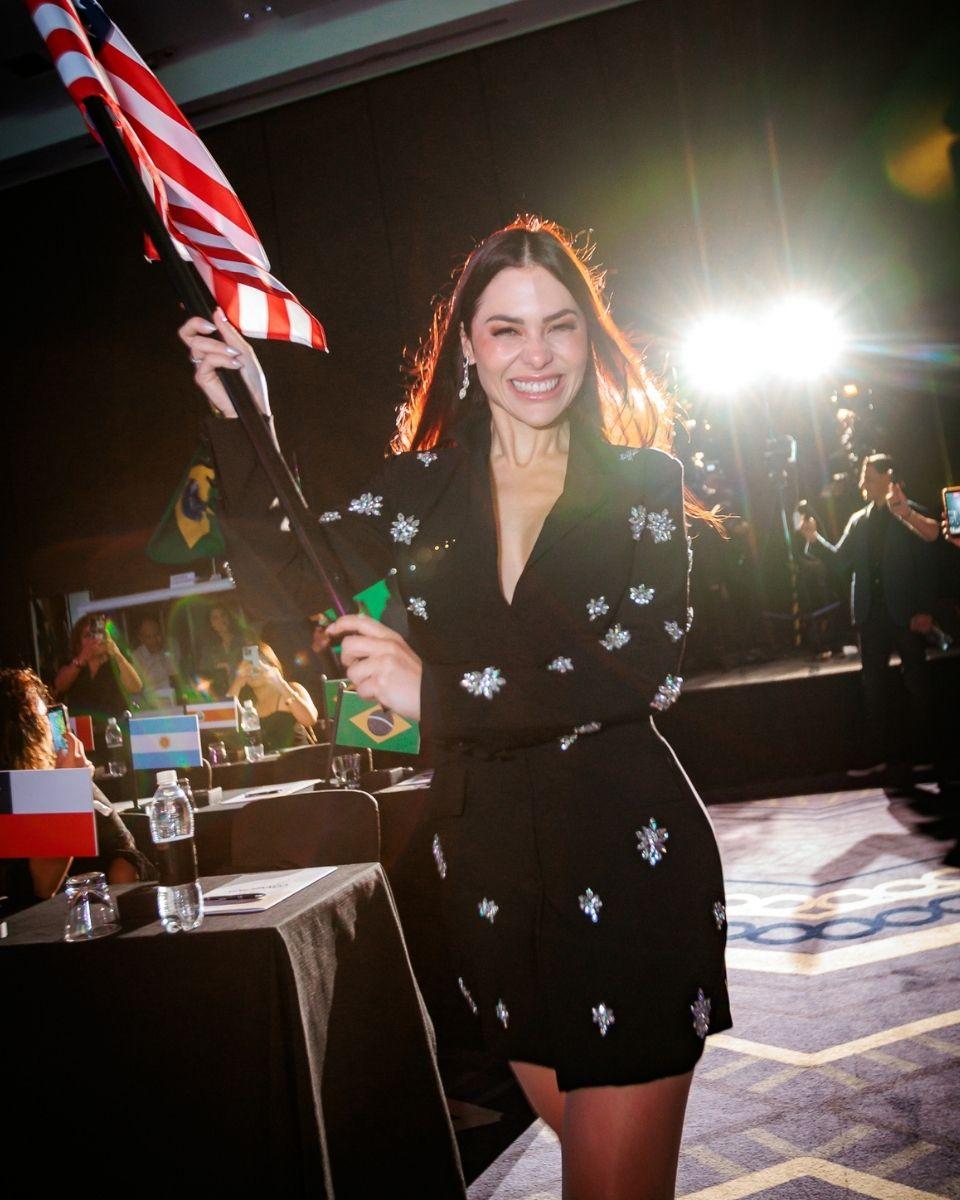 TRUSS Global Ambassador Simone Borges carries a flag during the event's opening ceremony.