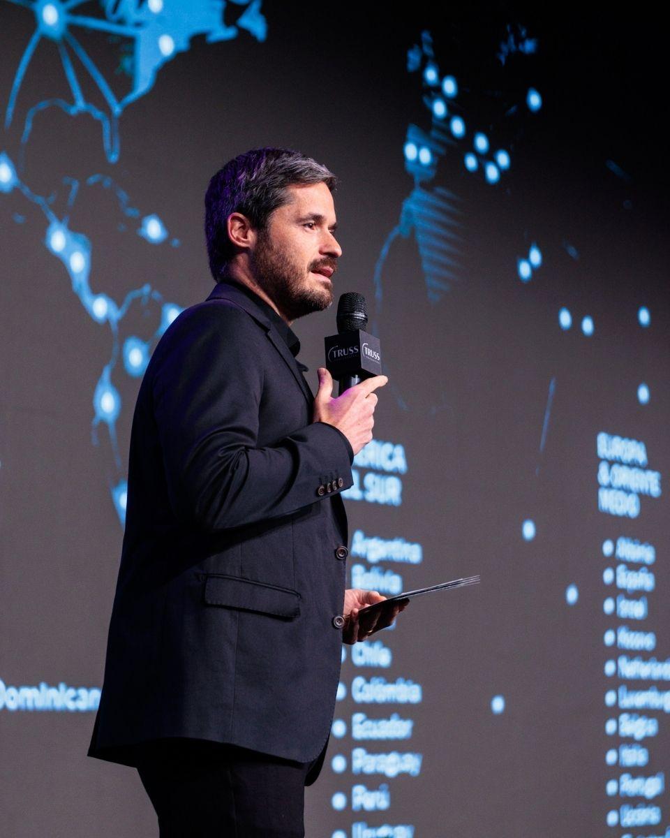 Rafael Almeida welcomes attendees from the stage during the opening session of TRUSS Connection Global.