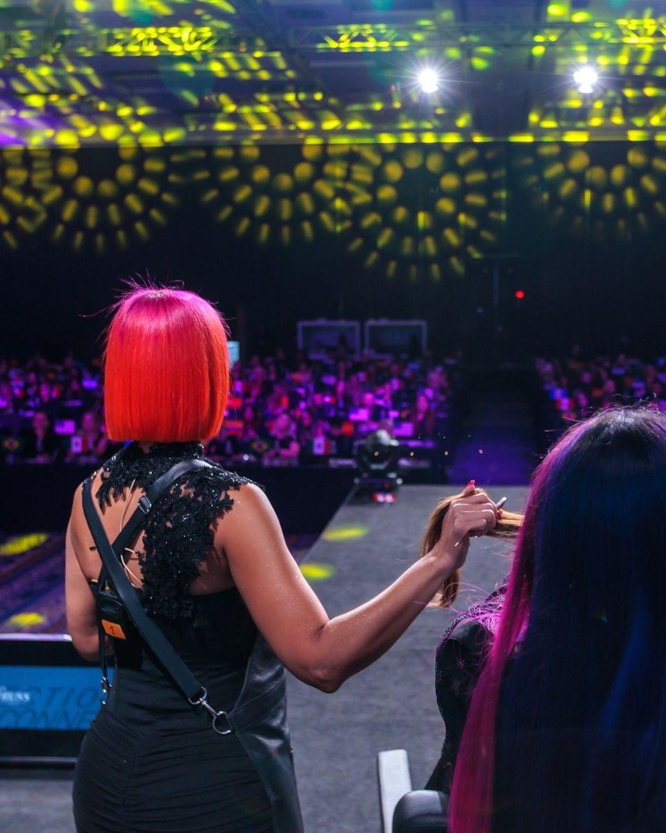 Lisa Hernandez demonstrates color techniques onstage during a TRUSS Professional education class.