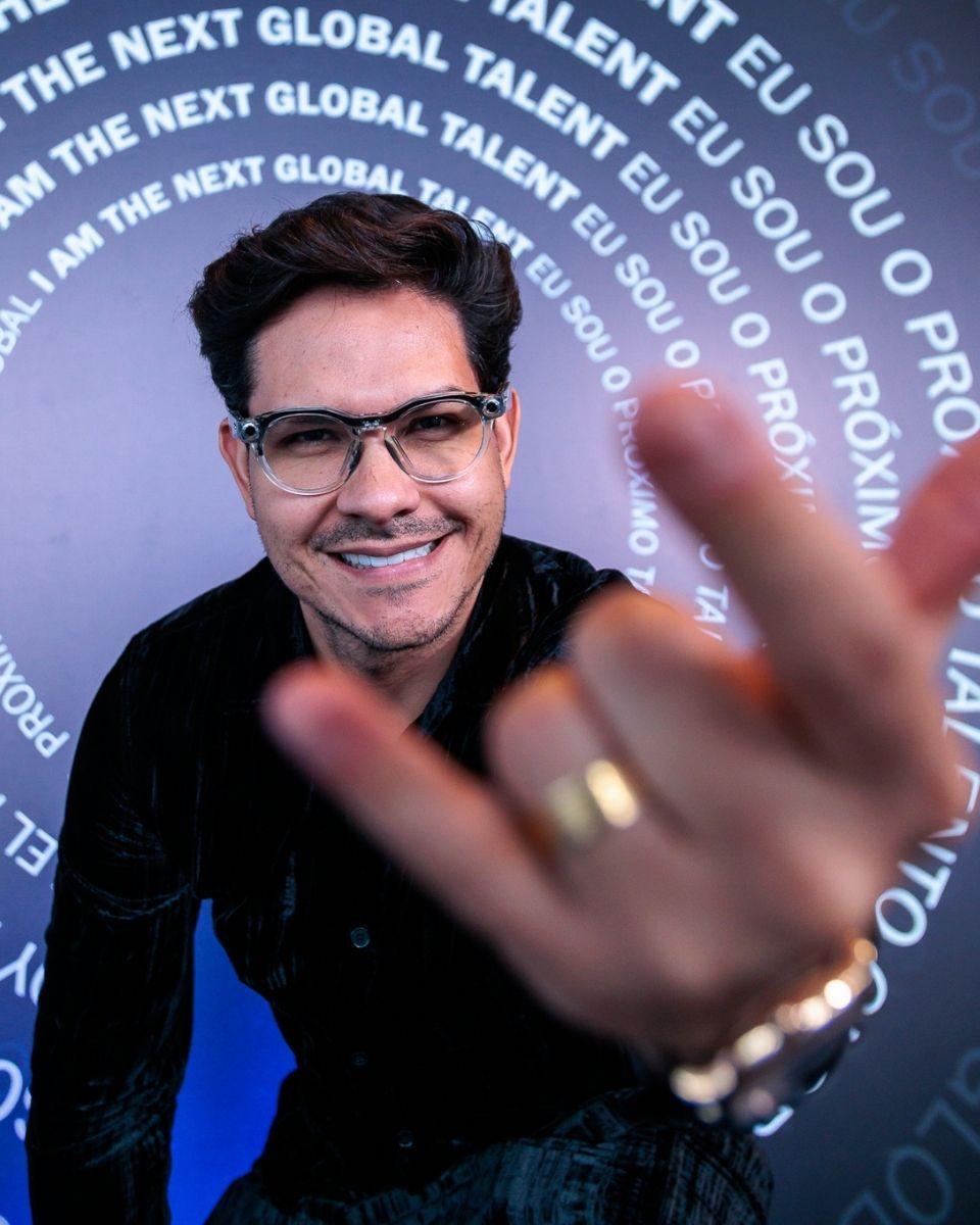Everton Muller poses in front of a “The Next Global Talent” branded backdrop during a TRUSS Professional event.