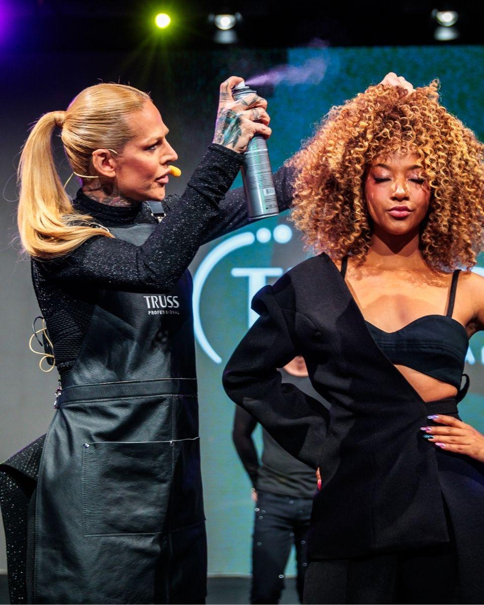 TRUSS Global Ambassador Melissa Schlukebier demonstrates curly hair techniques on a model during a live education class.