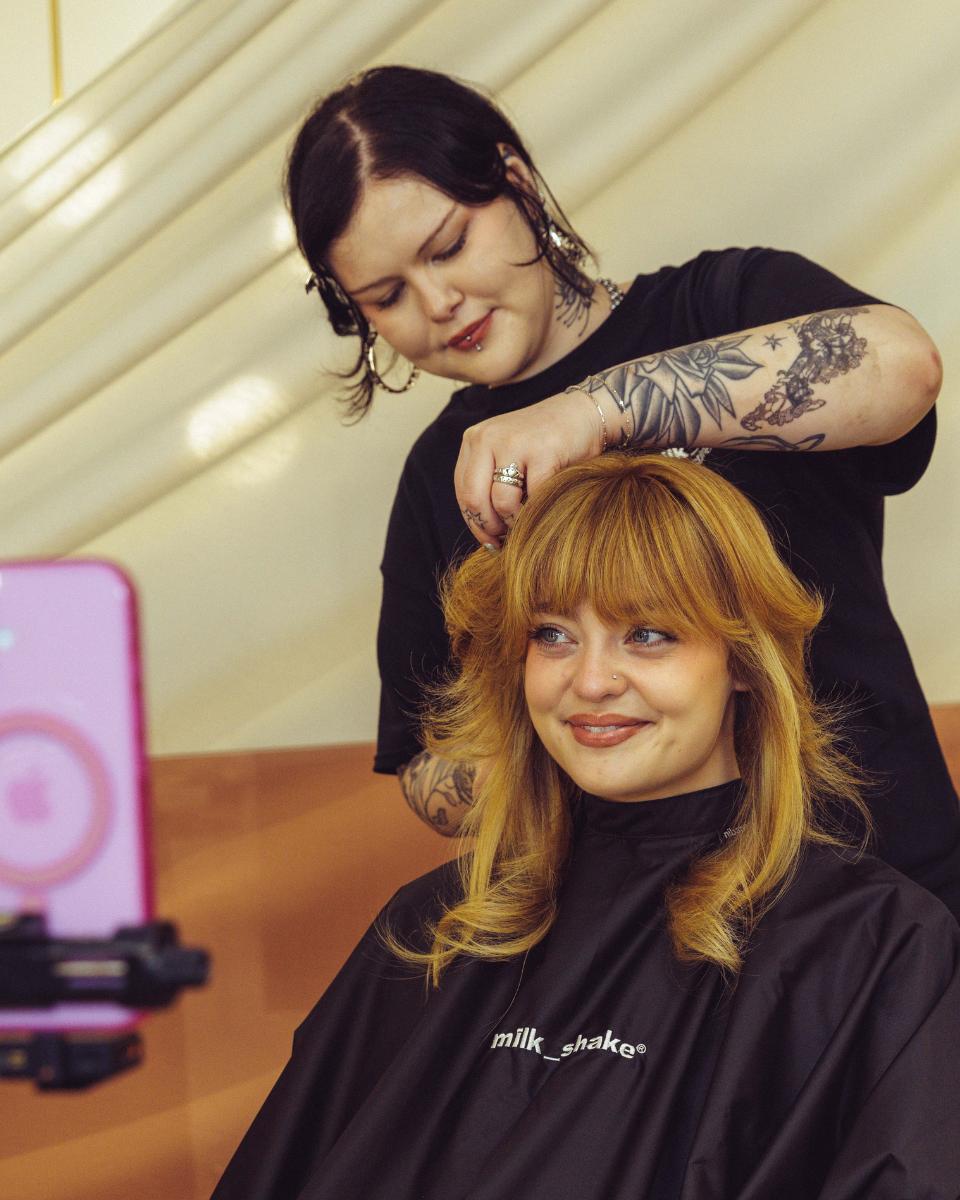 A milk_shake stylist styles Lauren Freas’ golden blonde hair during the Everlasting Bonds press launch event.