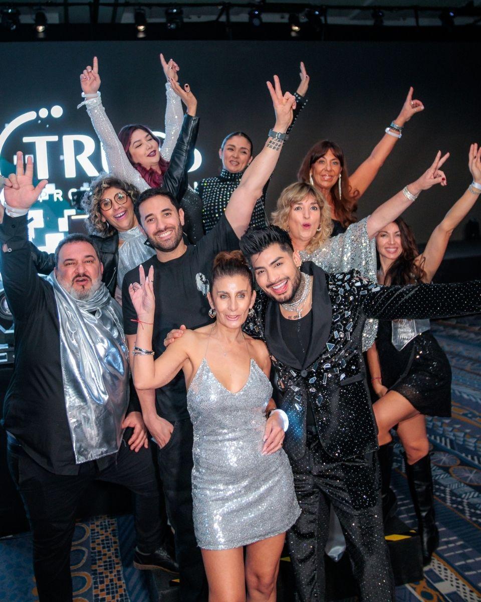 Guests pose together on the dance floor during a silver-themed TRUSS Professional event party.