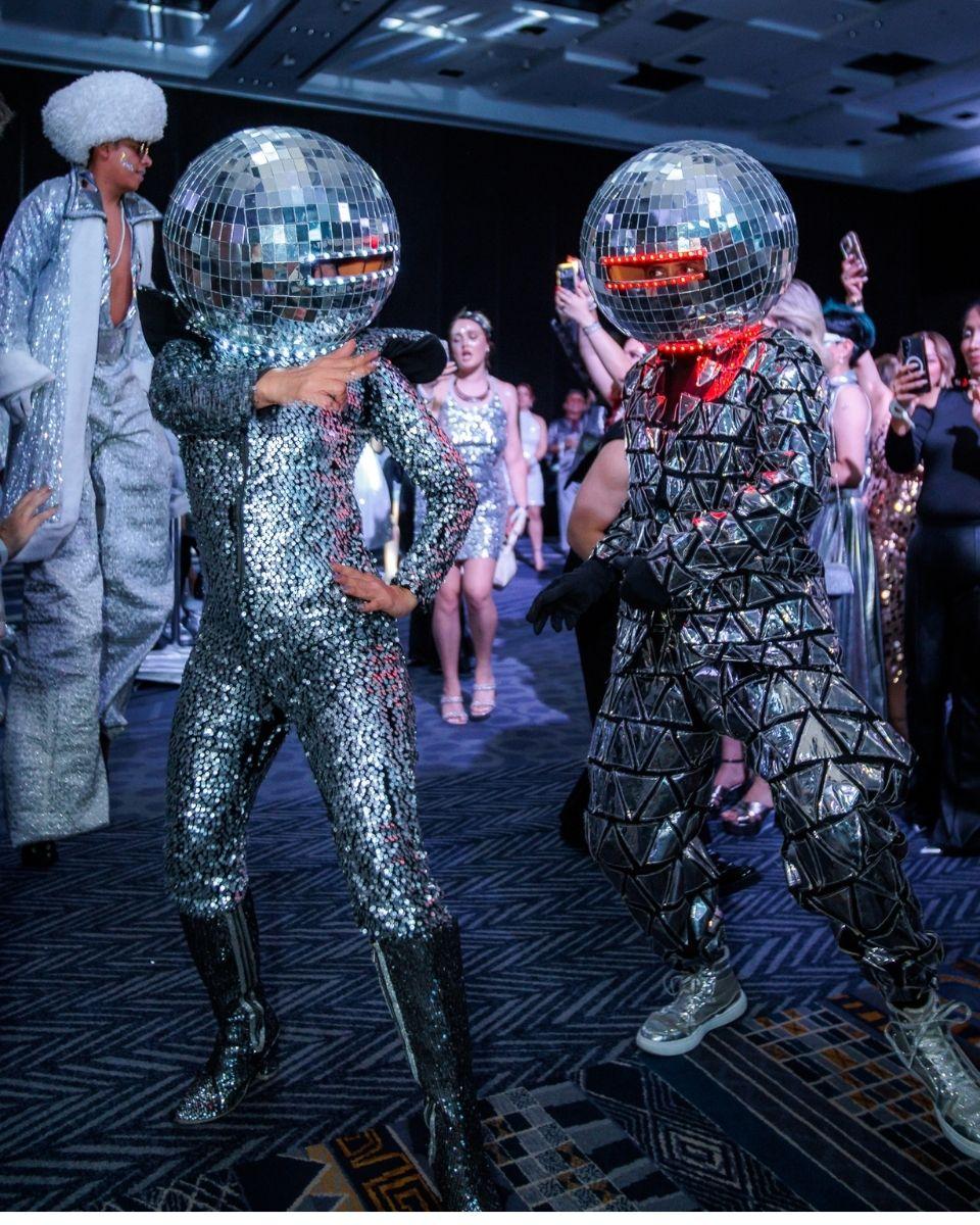 Performers brought the silver theme to life with disco ball costumes, stilt walkers and high-energy dancing.