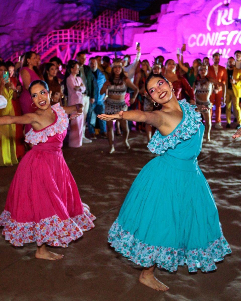 Traditional dancers perform in colorful dresses during an outdoor TRUSS Professional celebration at a historical site in Lima, Peru.