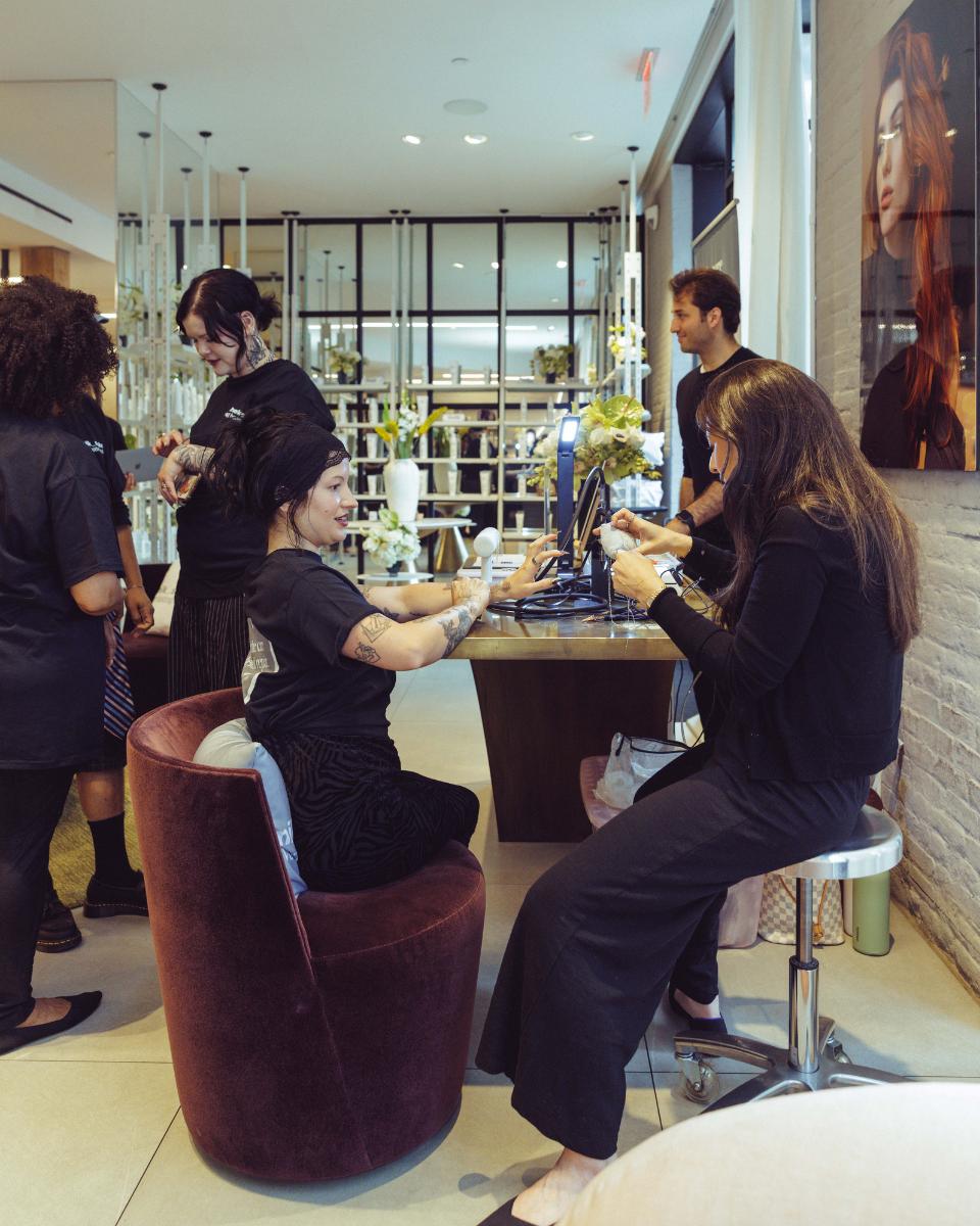 Guests visit the permanent jewelry station during the milk_shake Everlasting Bonds launch event.