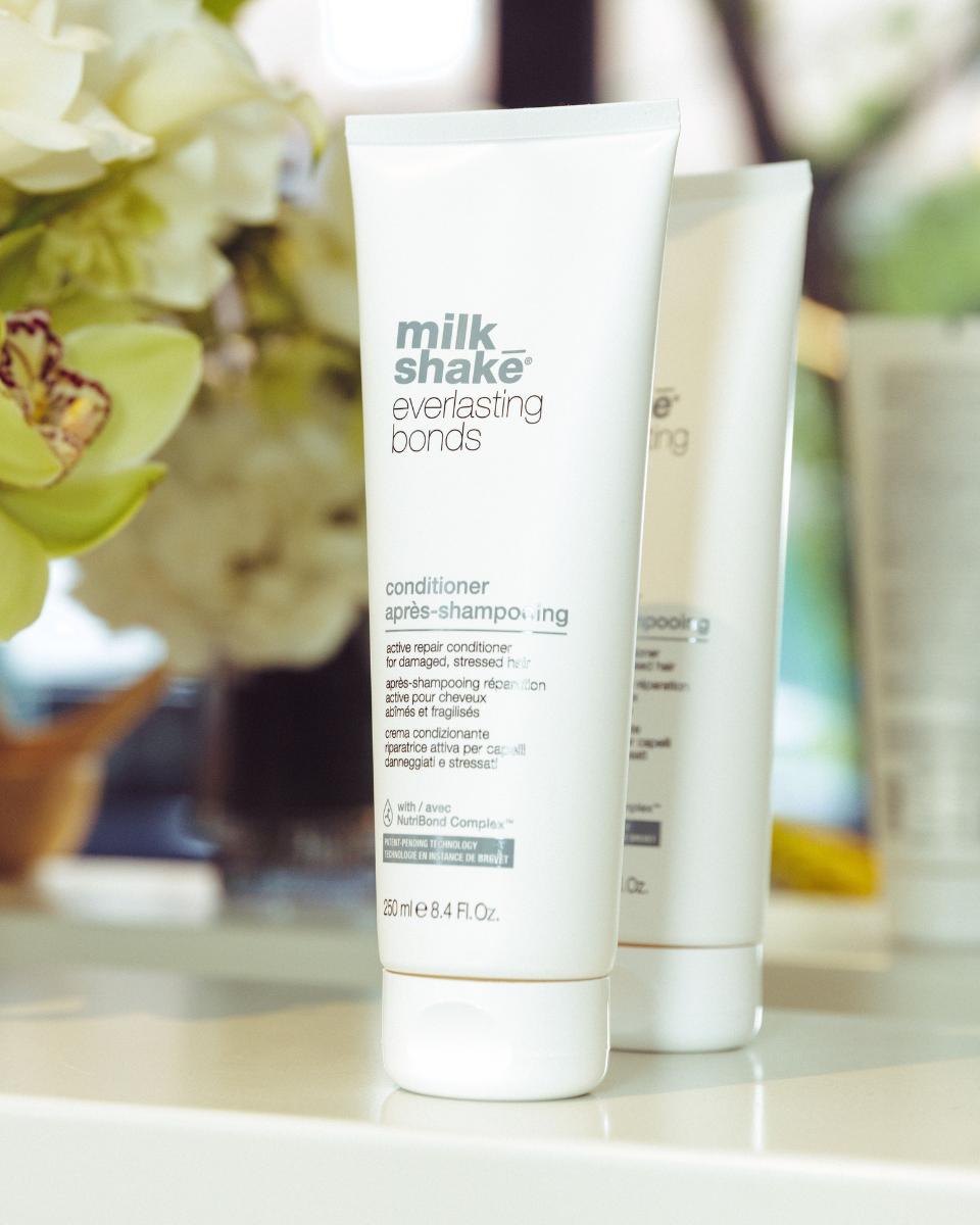 Close-up of milk_shake Everlasting Bonds Active Repair Conditioner displayed with florals at the launch event.