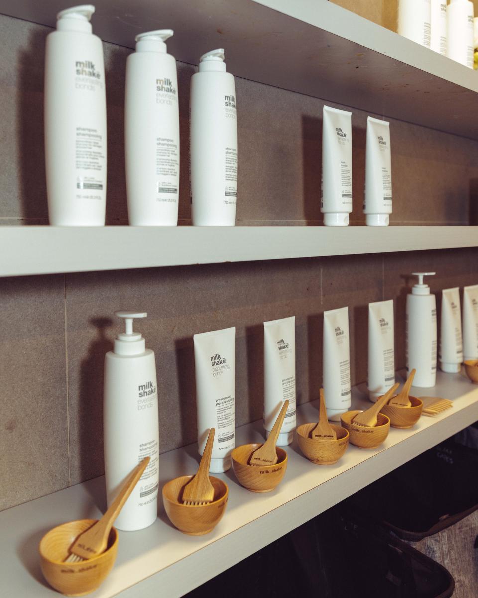 milk_shake Everlasting Bonds products and wooden bowls are arranged along the salon backbar.