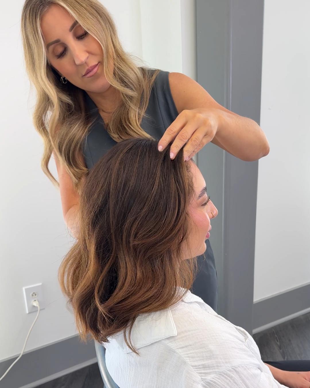 stylist massaging serum in scalp