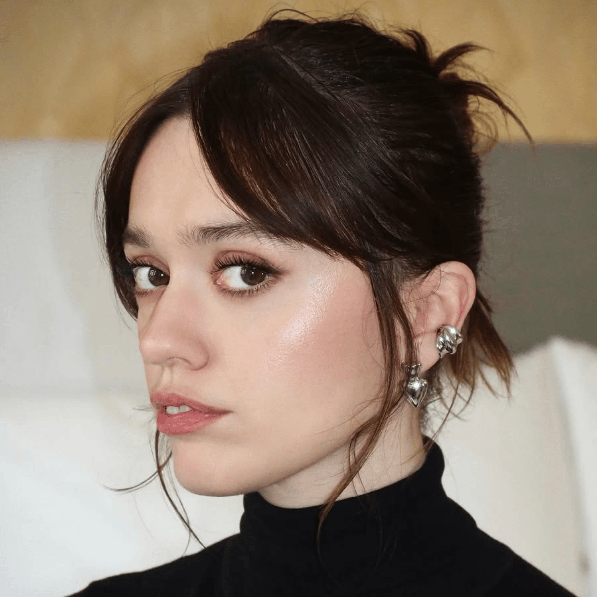 Aimee Lou Wood's glossy brunette updo with soft, lived-in depth and subtle tonal blends