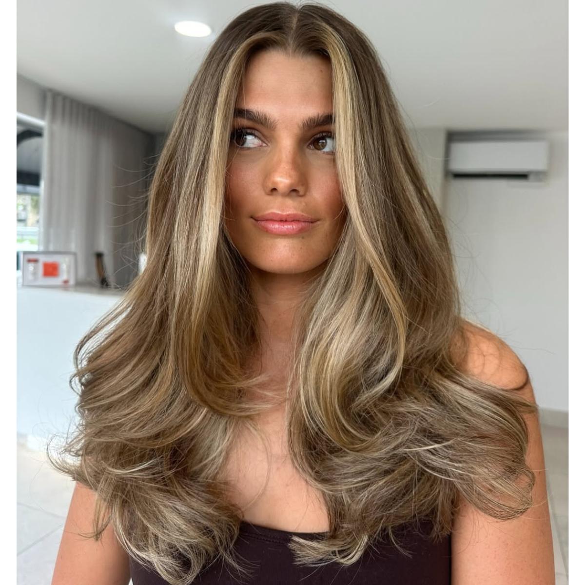 brown butter blonde hair with a bouncy blowout