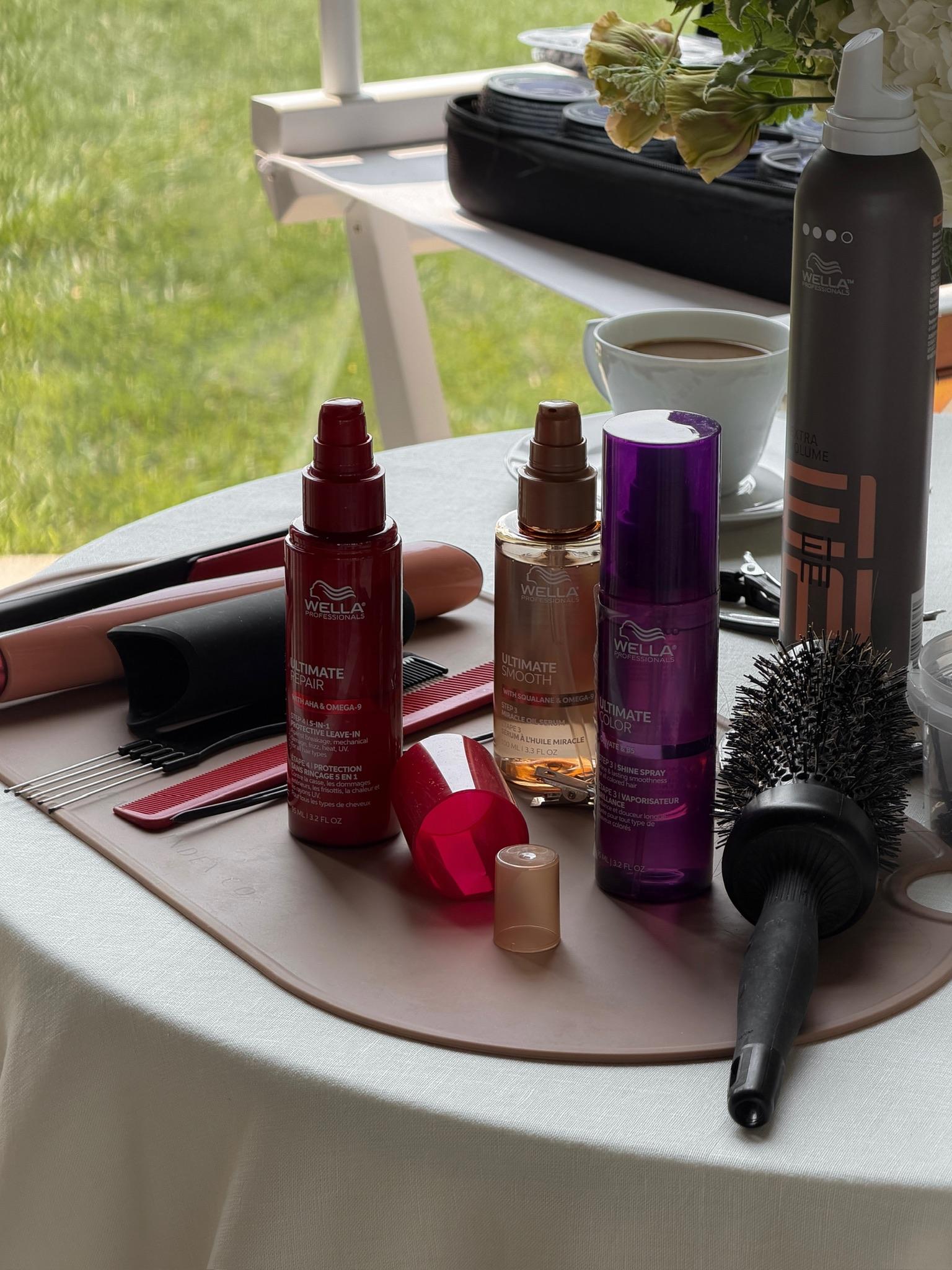 Wella Professionals styling and finishing products arranged on a bridal hairstyling station before Paige Lorenze's wedding hair appointment.