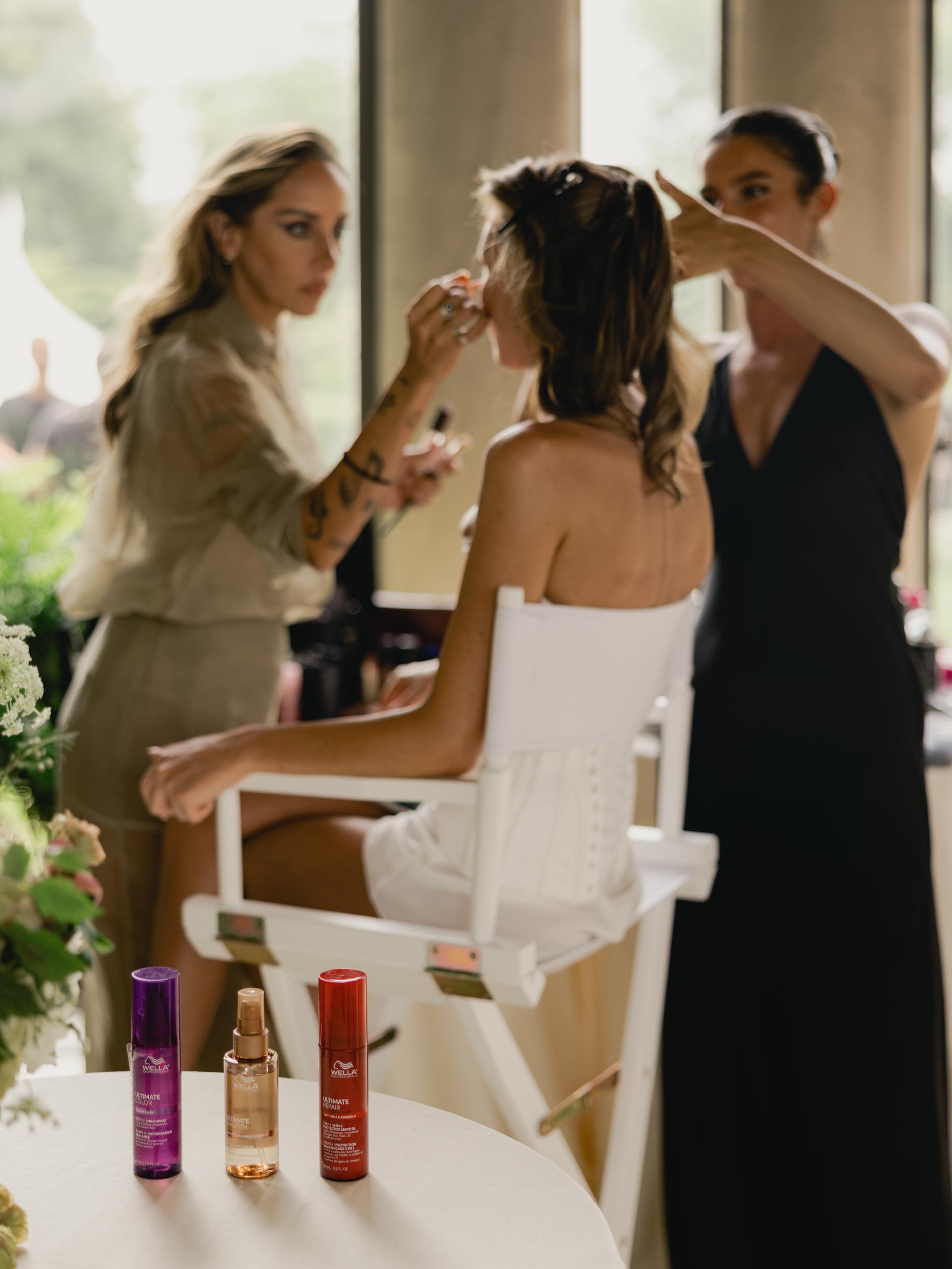 Behind the scenes as Paige Lorenze's soft brunette highlights are styled into a sleek bridal updo on her wedding day.