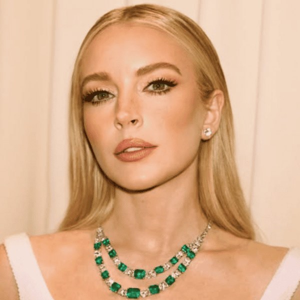 Lindsay Lohan at the 2025 Vanity Fair Oscars Party with sleek, soft waves in a white dress on the red carpet.