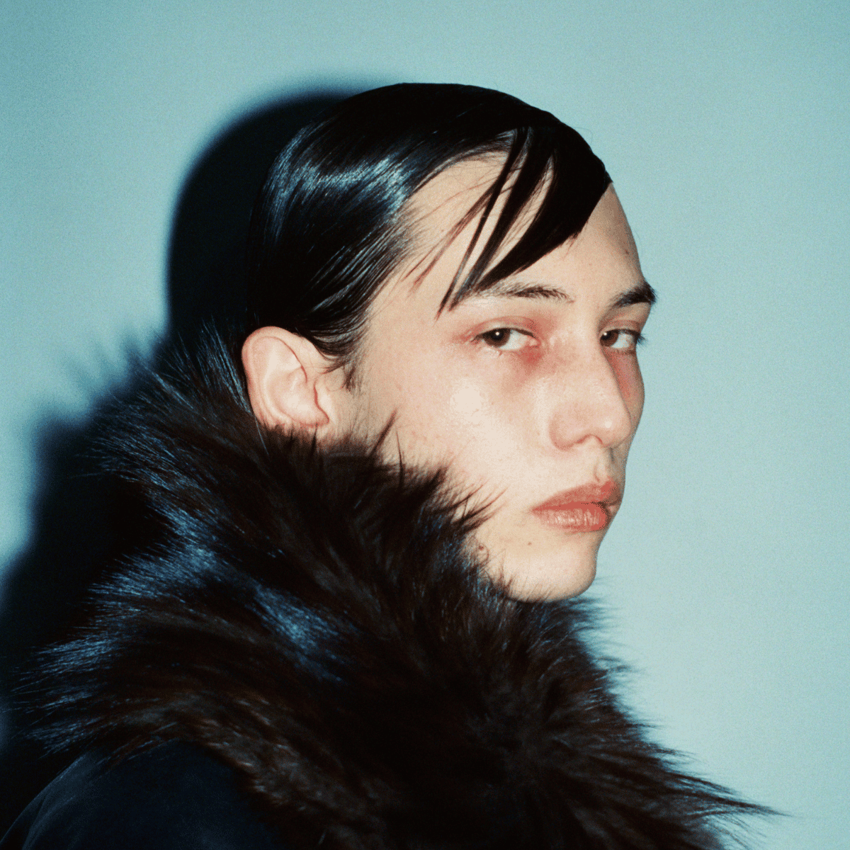 Model with wet-look, separated fringe hairstyle by Mike Martinez at Paris Fashion Week AW25, styled using Fatboy products