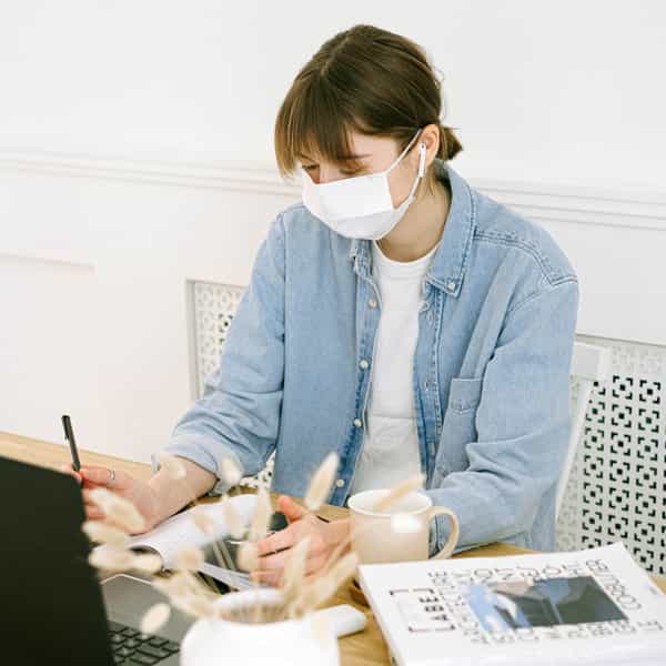 woman-in-face-mask-working-at-home-4240607