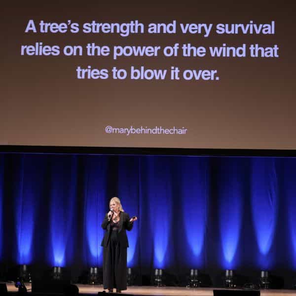 Mary Rector at the Orpheum Theatre in Los Angeles, California giving a motivational business presentation with tips on management, AI and social media for hairdressers.