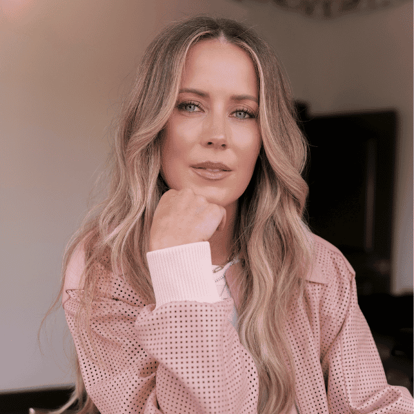 Headshot of Celebrity hairstylist Nikki Lee in a pink long sleeve shirt.