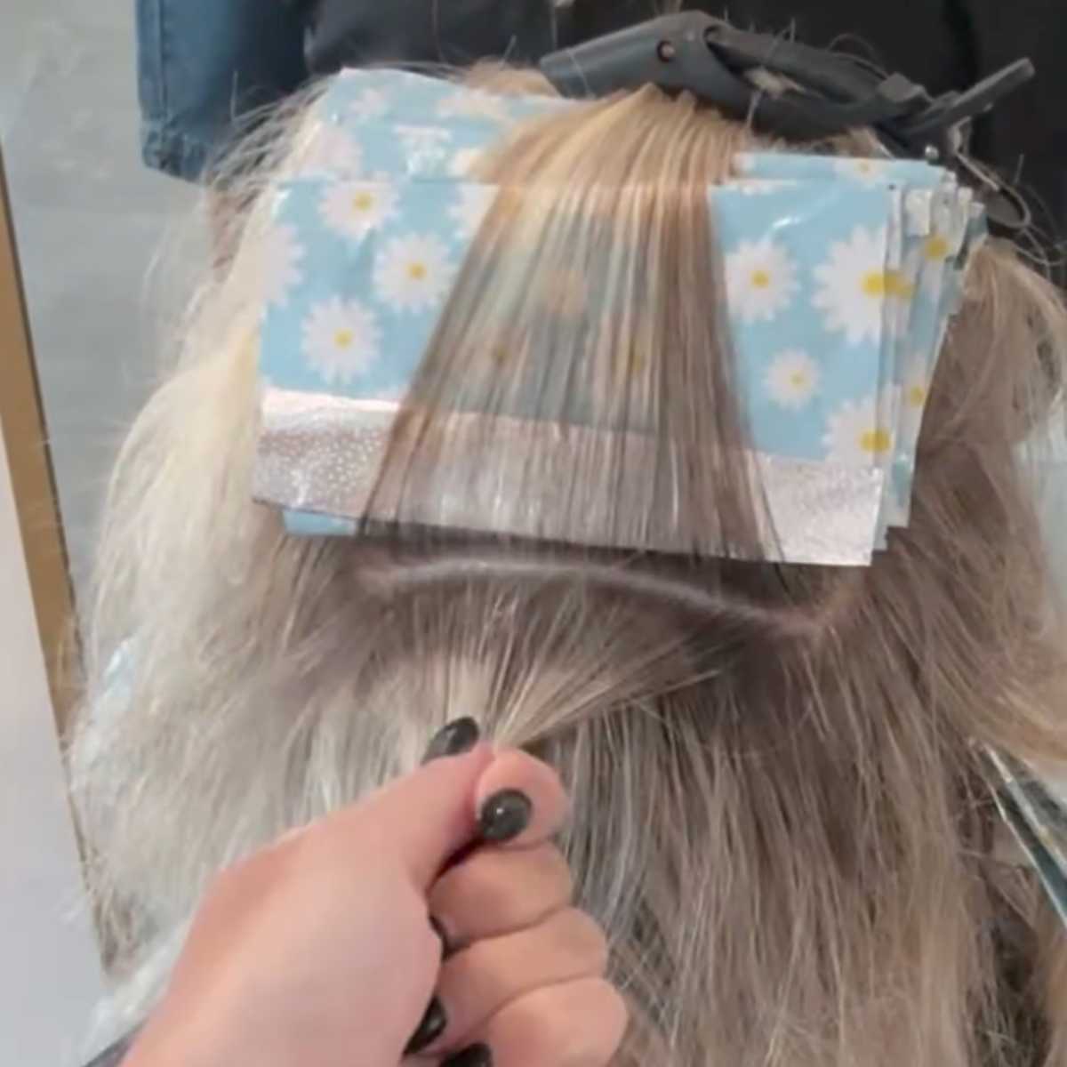leaving a section of hair pinned to the top of foils with another ready to be colored