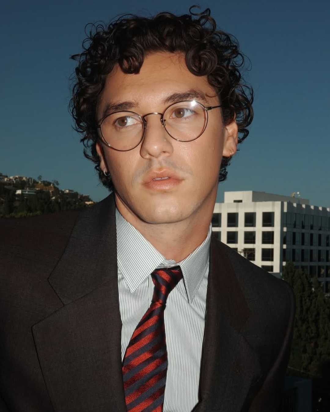 Close-up of Belmont Cameli's hockey-inspired haircut with curly texture, separation and natural volume.