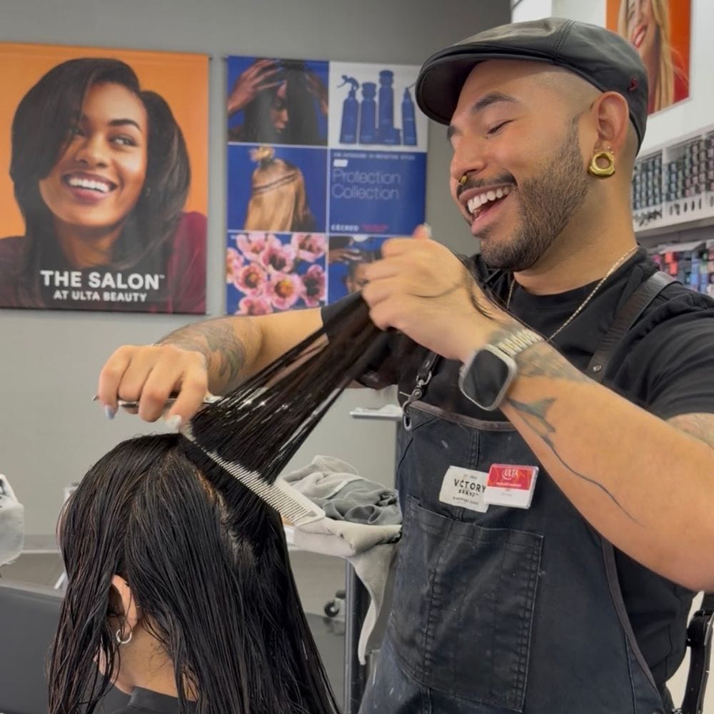 Stylist Leo Valencia performing a consultation and sectioning a client’s hair at the Ulta Beauty salon.