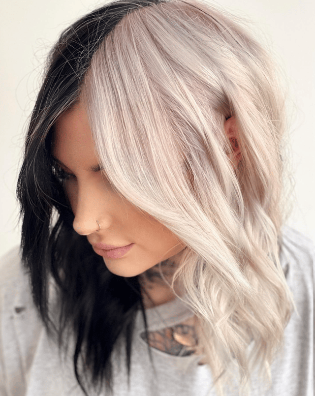 Woman with half black half blonde split dyed hair