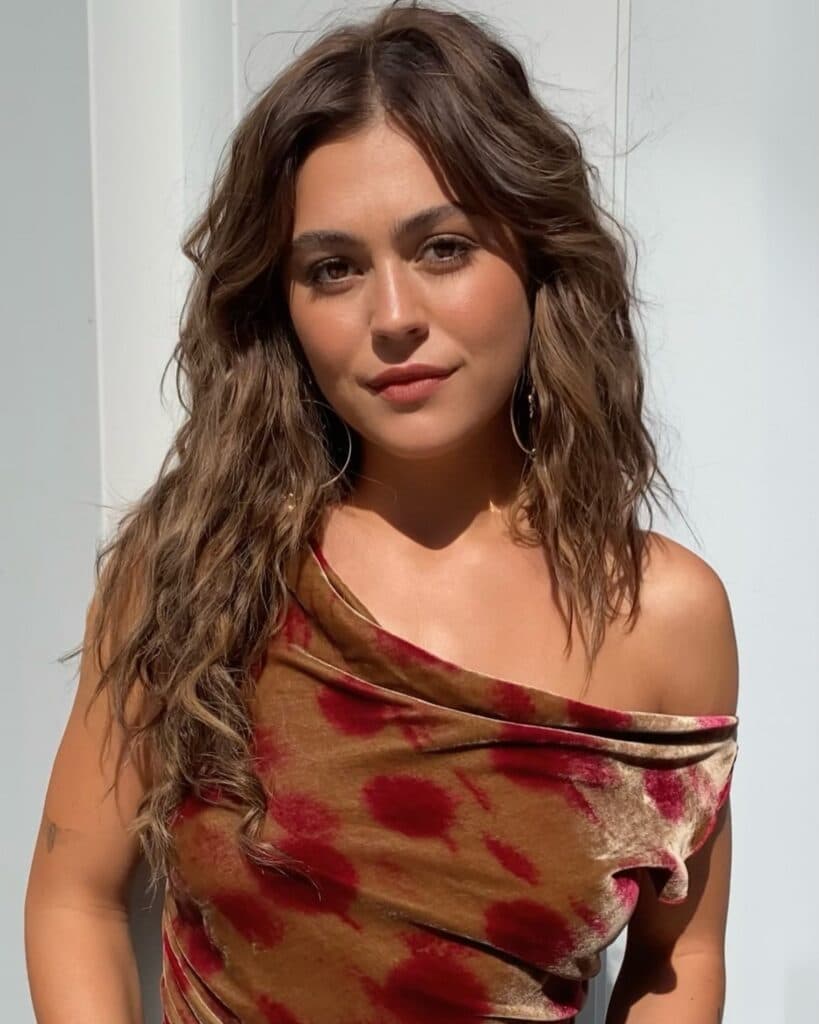 Mika Abdalla wearing Allie Hayes' signature shag haircut with tousled texture and face-framing layers during the Off Campus press tour.