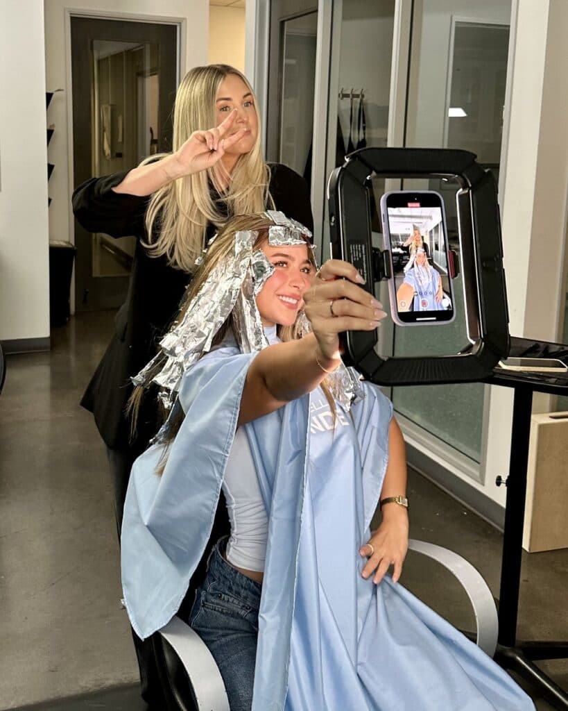Behind the scenes of the blonding process, showcasing strategic foil placement designed to maintain dimension while maximizing brightness.